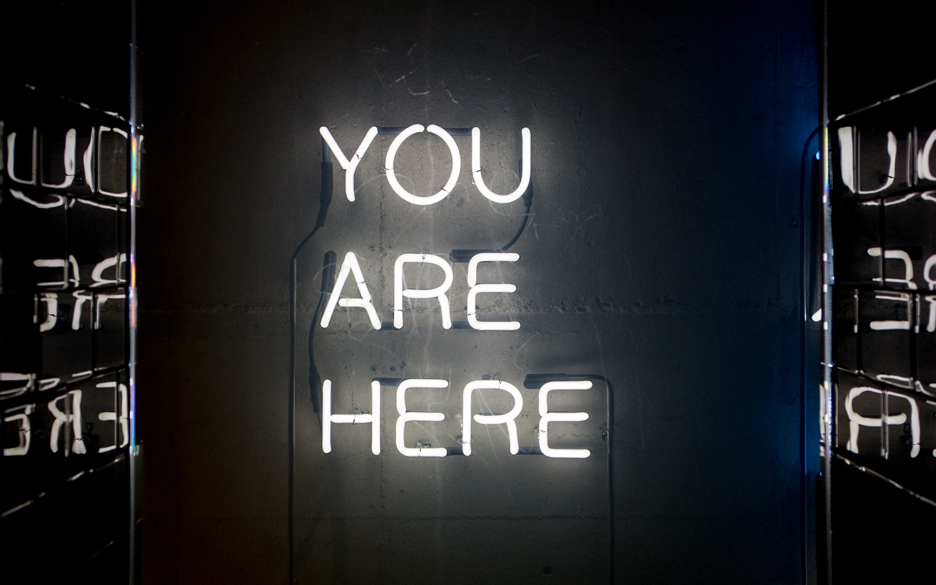 'You are here' in white neon lights